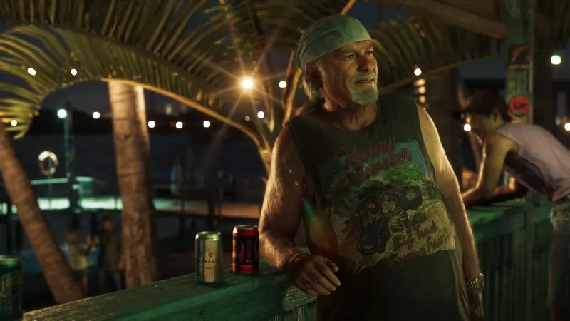 Brian Heder stands at a waterfront bar at night under string lights
