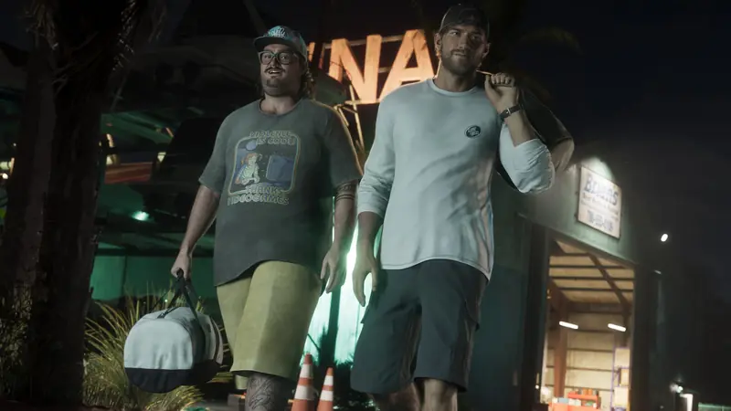Cal Hampton and Jason walk out of a warehouse at night carrying duffel bags