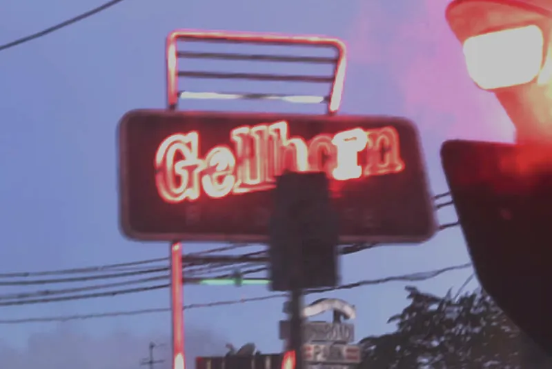 The neon Gellhorn Roadhouse sign glowing at dusk