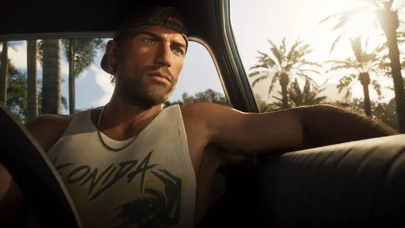 Jason Duval drives an old car with his arm across the seat, palm trees outside