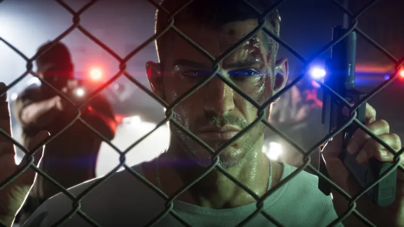 Jason behind a chain-link fence, lit red and blue by police lights