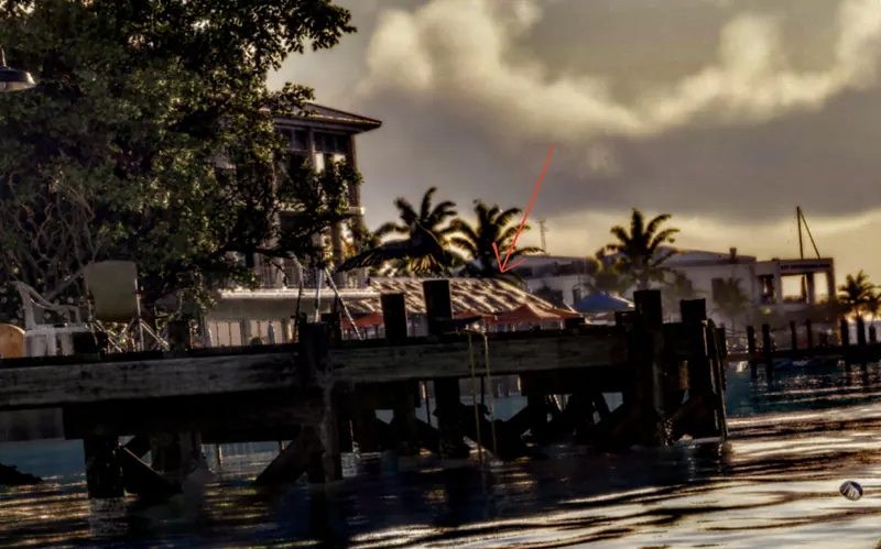 A wooden dock and stilt houses at sunset in Key Lento
