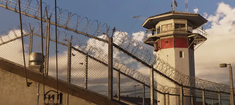 A guard tower and razor wire fence at the Leonida prison in Hamlet