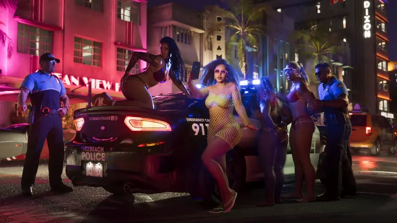 Police officers stop a group of partygoers on Ocean Drive at night