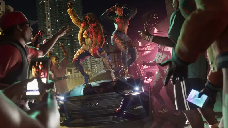 Women dance on a car roof at a night-time street party in the city