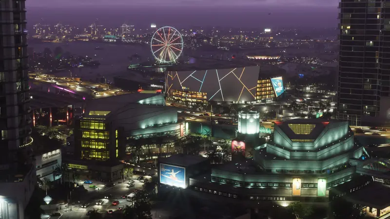 The Vice City waterfront at night, with an arena and a Ferris wheel